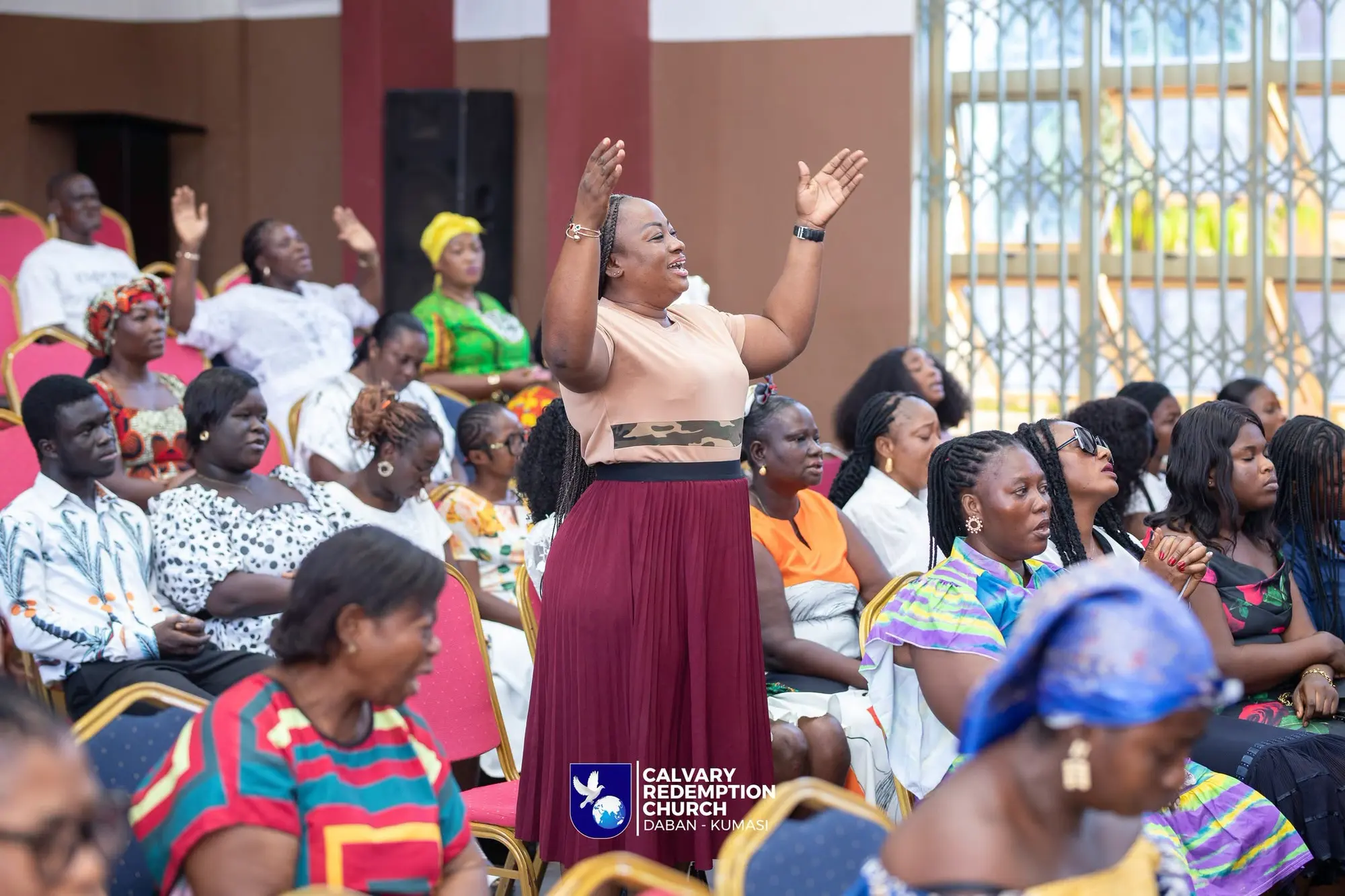 Worshippers lifting their hands during a service