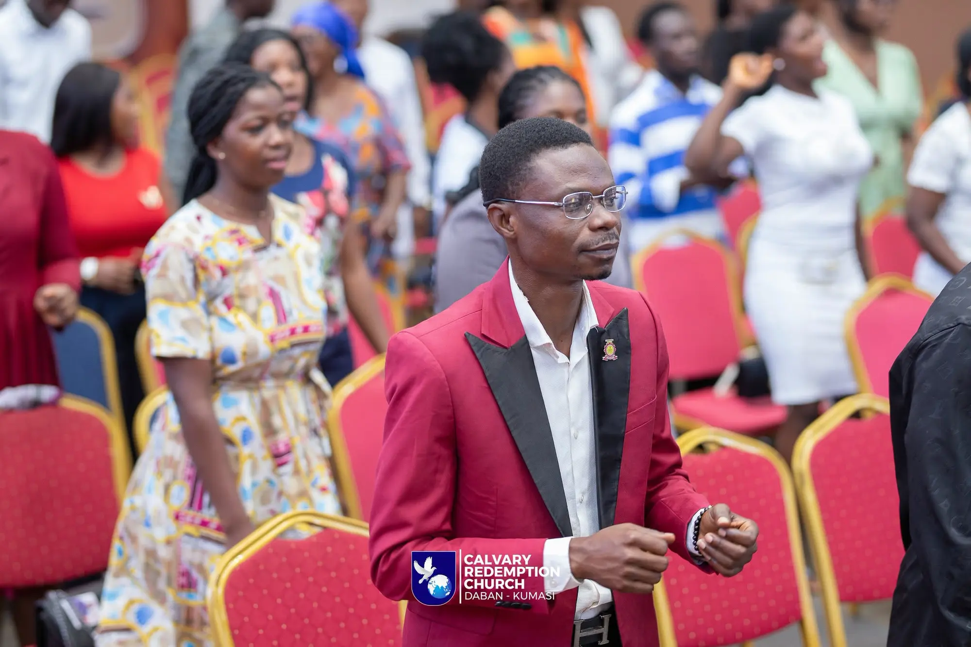A young man worshipping in the aisle